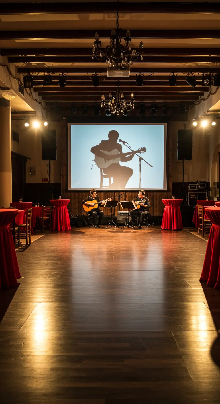 Scène avec deux guitaristes et un grand écran en fond.